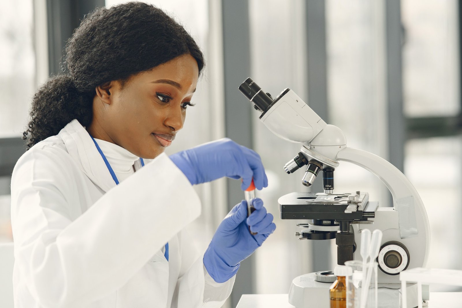 medical-doctor-girl-working-with-microscope-young-female-scientist-doing-vaccine-research